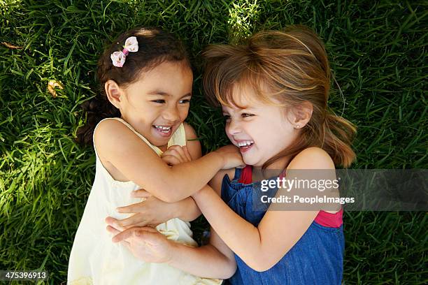 adorable laughter - lying down friends girls stock pictures, royalty-free photos & images