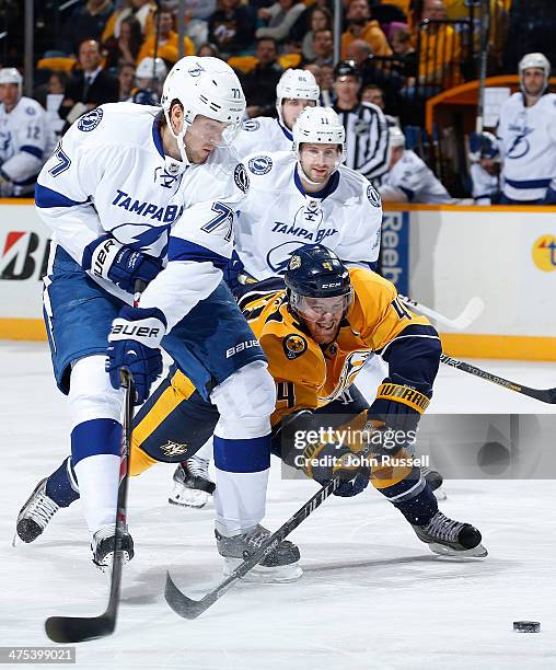 Ryan Ellis of the Nashville Predators dives for the puck against Victor Hedman of the Tampa Bay Lightning at Bridgestone Arena on February 27, 2014...