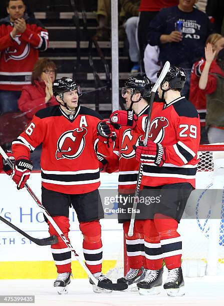 Patrik Elias of the New Jersey Devils is congratulated by teammate Ryane Clowe after Elias scored an empty net goal in the third period against the...