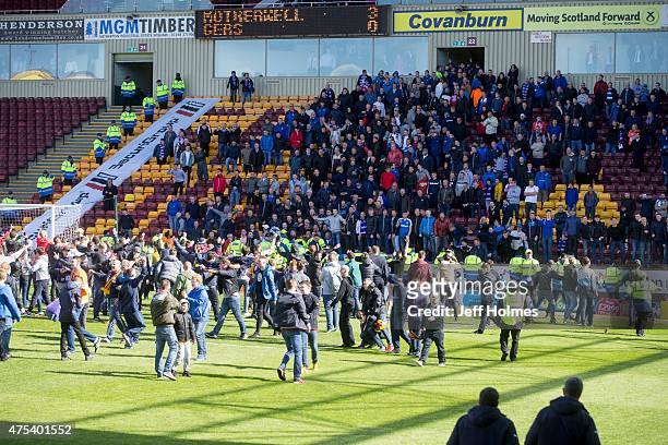 Motherwell fans on the pitch appear to taunt the Rangers fans in the stand at the end of the Scottish Premiership play-off final 2nd leg between...