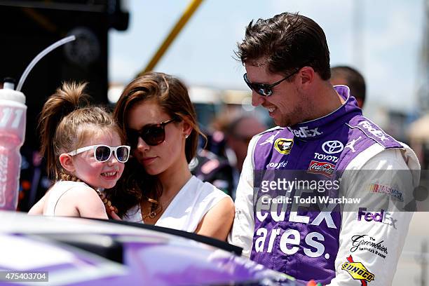 Denny Hamlin, driver of the FedEx Cares Toyota, takes part in pre-race ceremonies with girlfriend Jordan Fish and daughter Taylor James Hamlin before...