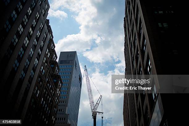 Damaged crane hangs over Madison Avenue following an accident May 31, 2015 in New York City. At least ten people were injured when a crane lifting a...