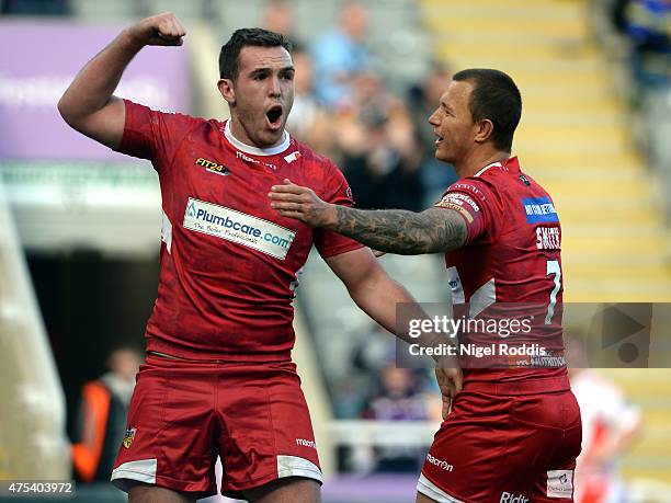 Reece Lyne of Wakefield Trinity Wildcats celdebrates scoring a try with Tim Smith during the Super League match between Castleford Tigers and...