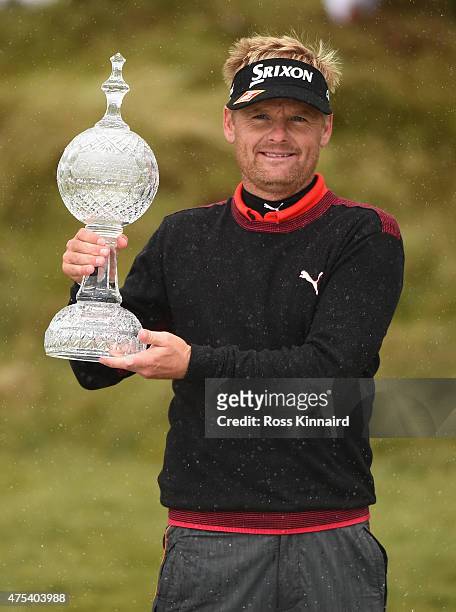 Soren Kjeldsen of Denmark poses with the trophy after his victory in a playoff during the Final Round of the Dubai Duty Free Irish Open Hosted by the...