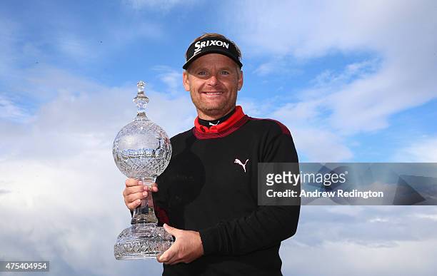 Soren Kjeldsen of Denmark poses with the trophy after his victory in a playoff during the Final Round of the Dubai Duty Free Irish Open Hosted by the...
