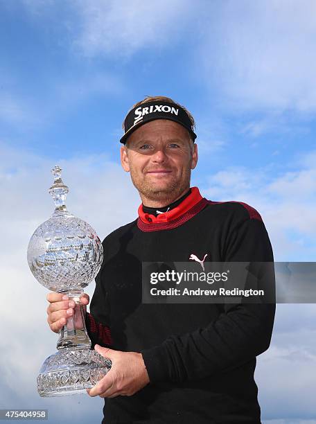 Soren Kjeldsen of Denmark poses with the trophy after his victory in a playoff during the Final Round of the Dubai Duty Free Irish Open Hosted by the...