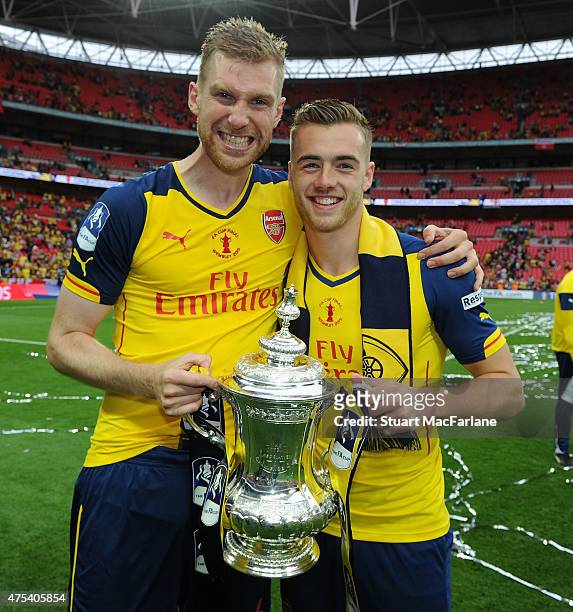 Arsenal's Per Mertesacker and Calum Chambers celebrates after the FA Cup Final between Aston Villa and Arsenal at Wembley Stadium on May 30, 2015 in...
