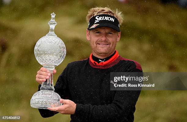 Soren Kjeldsen of Denmark poses with the trophy after his victory in a playoff during the Final Round of the Dubai Duty Free Irish Open Hosted by the...