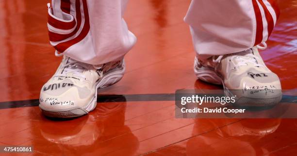 Toronto Raptors point guard Greivis Vasquez writes messages on the shoes he wore during the game between the Toronto Raptors and the Washington...