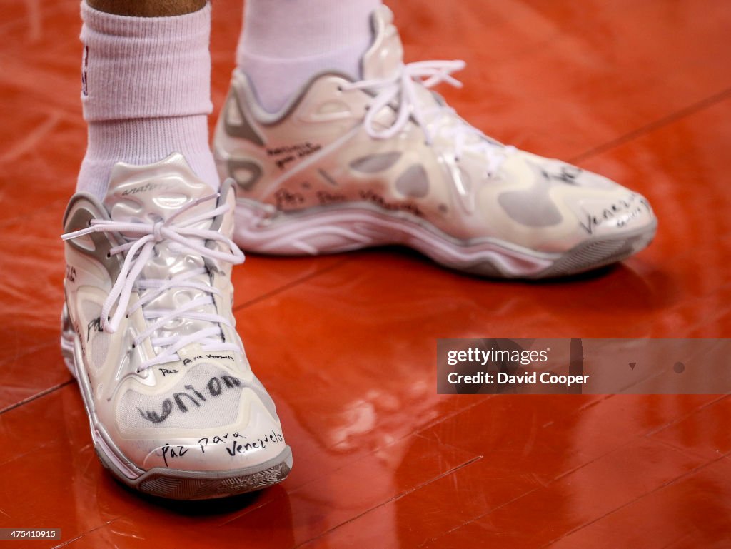 Toronto Raptors point guard Greivis Vasquez (21) writes messages on the shoes he wore