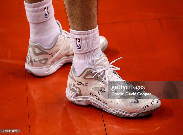 Toronto Raptors point guard Greivis Vasquez writes messages on the shoes he wore during the game between the Toronto Raptors and the Washington...