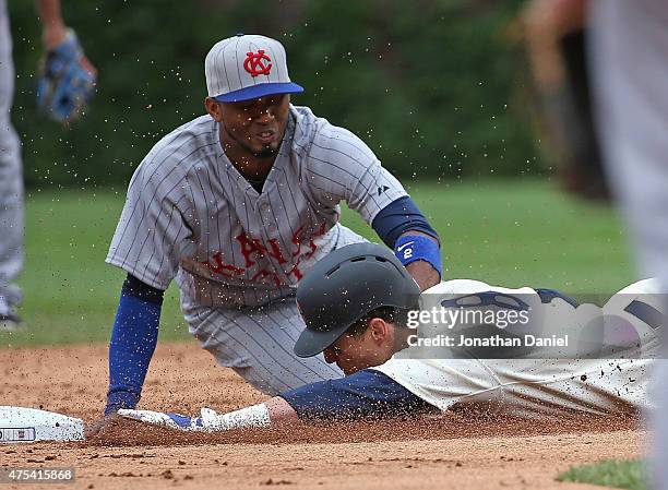 Chris Coghlan of the Chicago Cubs is tagged out at second base by Alcides Escobar of the Kansas City Royals in the 8th inning at Wrigley Field on May...