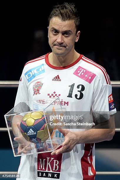 Momir Ilic of Veszprem poses with the trophy as best scorer of the season after losing the "VELUX EHF FINAL4" final match against FC Barcelona at...