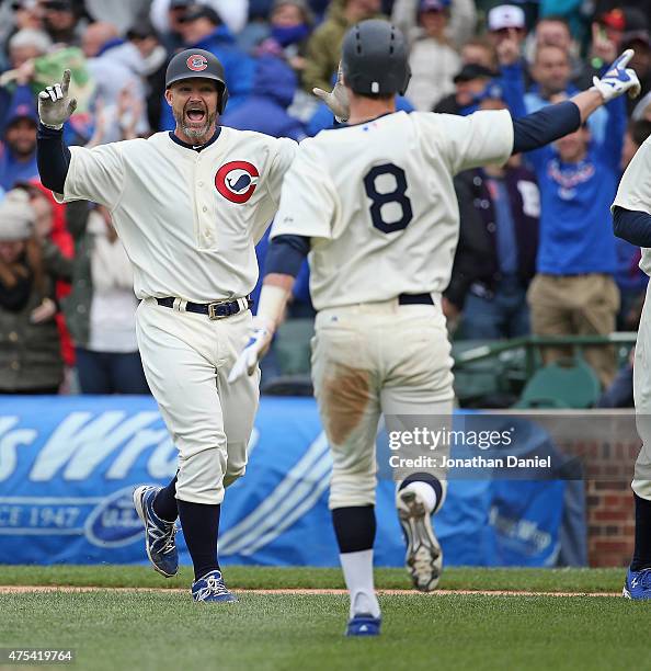 David Ross of the Chicago Cubs celebrates getting the game-winning hit, a single in the 11th inning, with teammate Chris Coghlan against the Kansas...