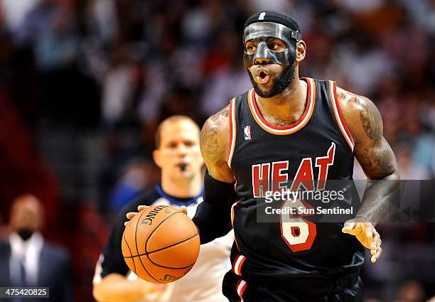 The Miami Heat's LeBron James heads up court with the ball against the New York Knicks in the second quarter at the AmericanAirlines Arena in Miami...