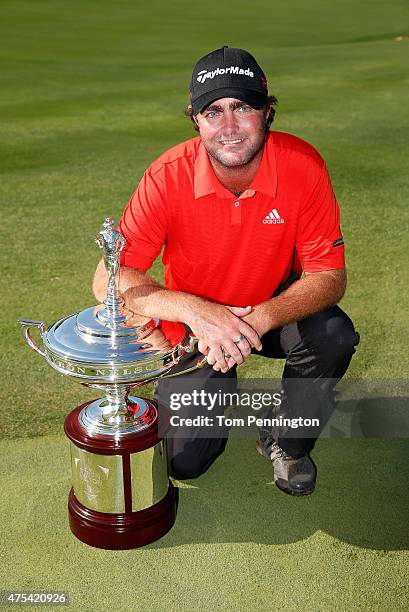 Steven Bowditch of Australia poses with the trophy after his four-stroke victory at the AT&T Byron Nelson at the TPC Four Seasons Resort Las Colinas...