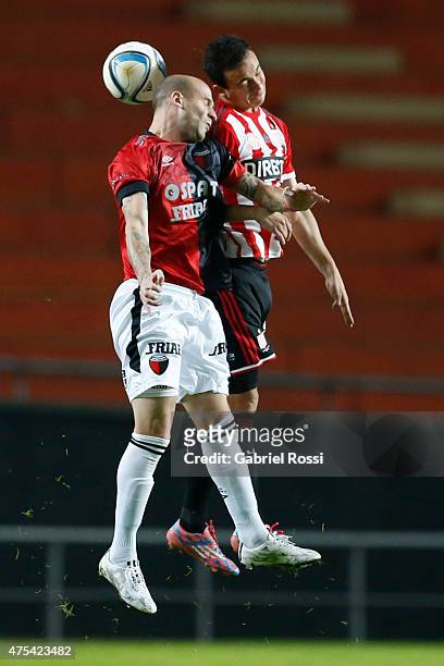 Leonardo Jara of Estudiantes jumps for the ball with Cristian Llama of Colon during a match between Estudiantes and Colon as part of 14th round of...