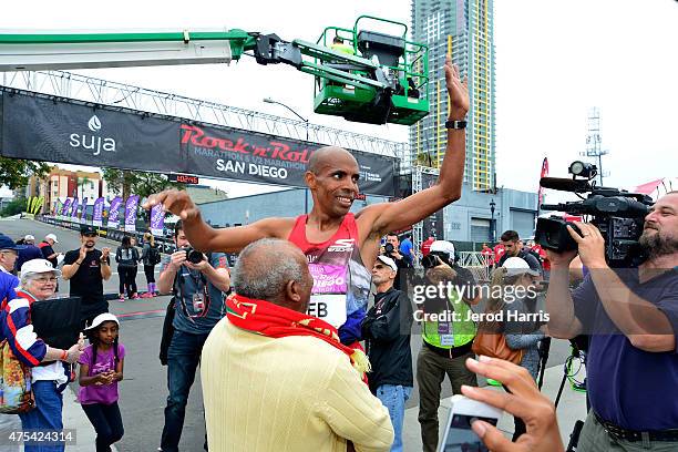 Olympic athlete Meb Keflezighi celebrates at the finish line after taking 2nd place in the Suja Rock 'n' Roll San Diego Marathon & 1/2 Marathon on...