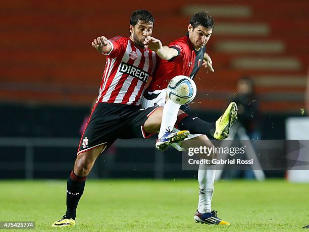 Sebastian Dominguez of Estudiantes fights for the ball with Lucas Alario of Colon during a match between Estudiantes and Colon as part of 14th round...