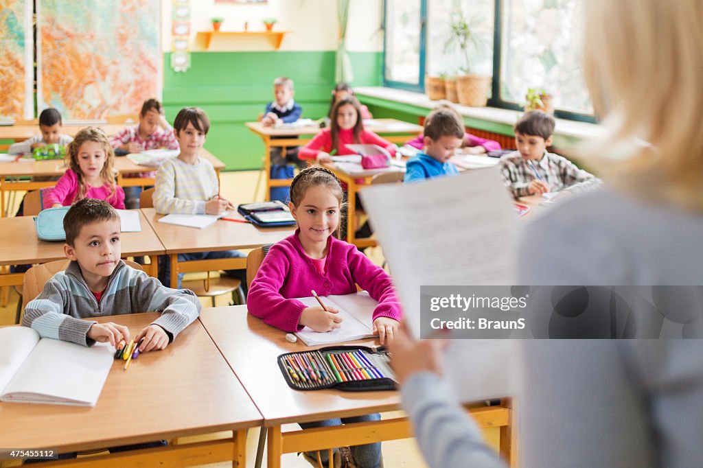 Large group of smiling elementary students attending a class.