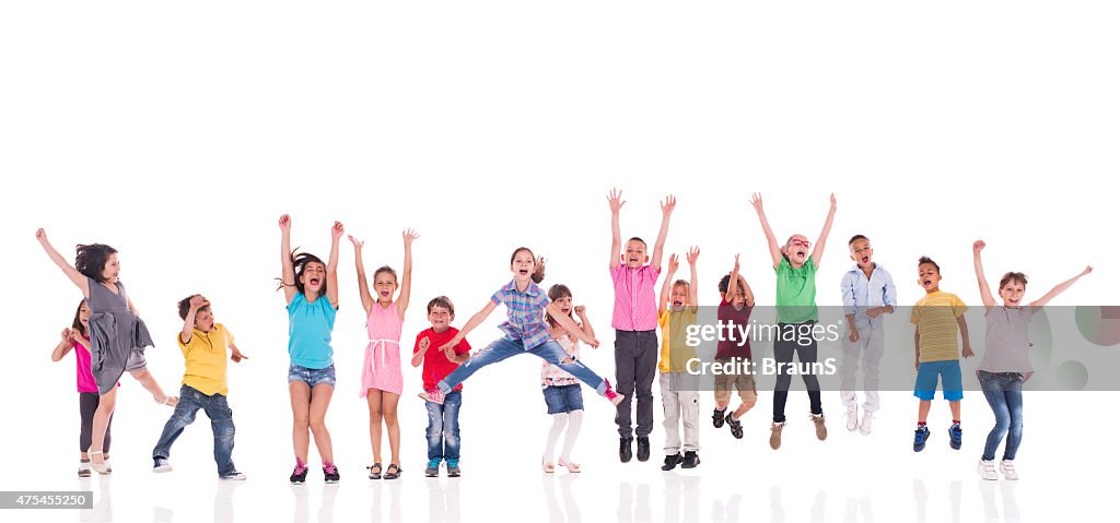 Large group of cheerful kids jumping together. Isolated on white.