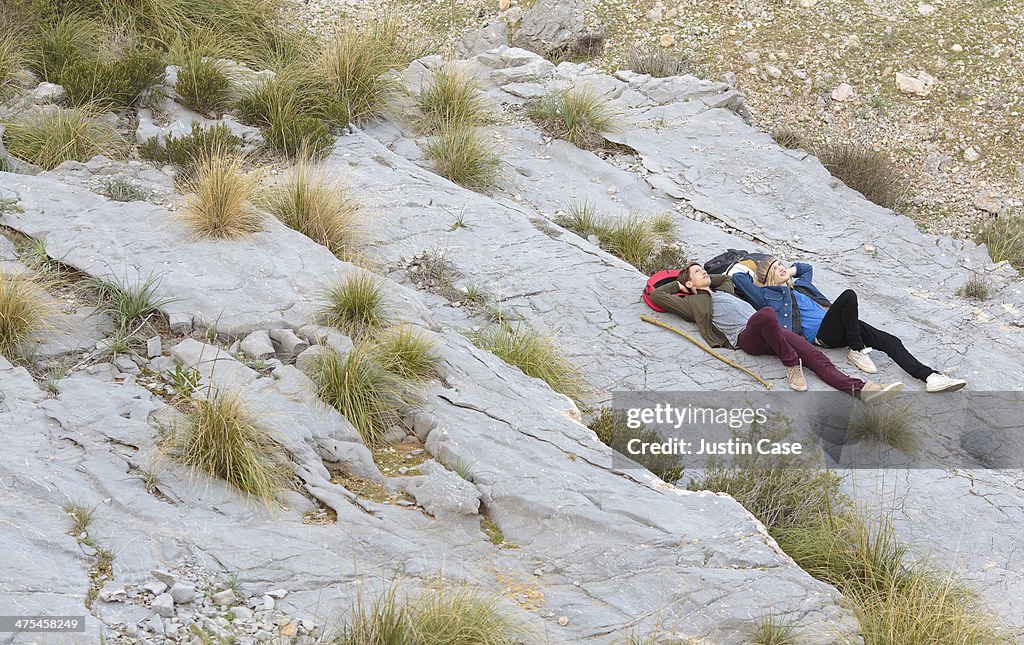 Two boys lying on the mountain after a long walk