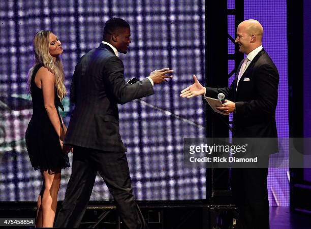 Player Benjamin Watson receives the Sports Impact Award from Tim Hasselbeck onstage during the 3rd Annual KLOVE Fan Awards at the Grand Ole Opry...