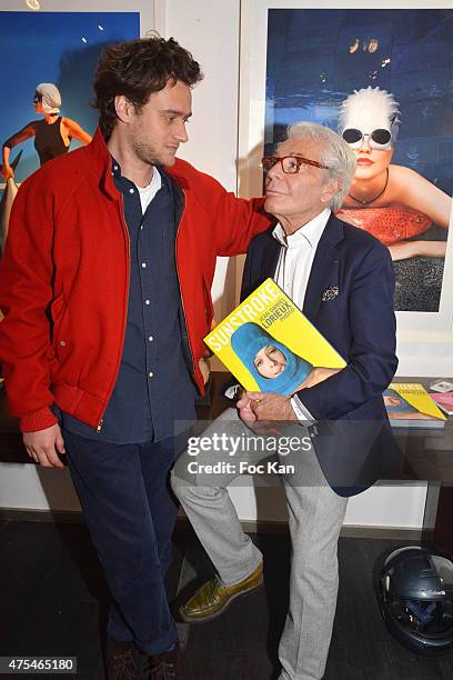 Photographer Nickolas Lorieux and his fatherJean Daniel Lorieux attend the Jean Daniel Lorieux Photo Exhibition book signing at Galerie Bernard Dulon...