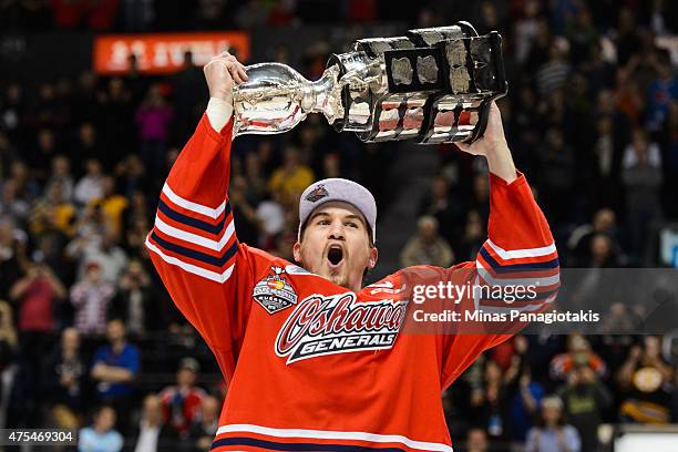 Josh Brown of the Oshawa Generals hoists the Memorial Cup in the air after defeating the Kelowna Rockets during the 2015 Memorial Cup Championship at...