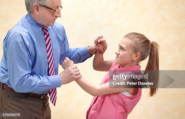 pupil fighting with teacher - strict parent stock-fotos und bilder