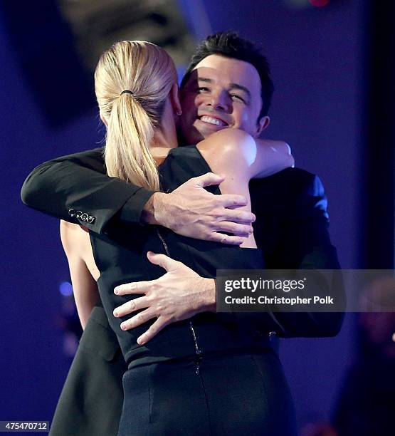 Actress Charlize Theron hugs honoree Seth MacFarlane as she presents him the LOUIS XIII Genius Award onstage at the 5th Annual Critics' Choice...