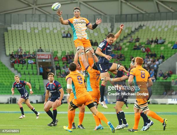 Francois Uys of the Cheeters throws the ball away from Scott Higginbotham of the Rebels during the round three Super Rugby match between the...