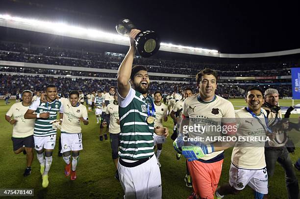 Nestor Araujo and Agustin Marchesin of Santos hold their trophy after winning against Queretaro in during their final match of Mexican Clasura 2015...