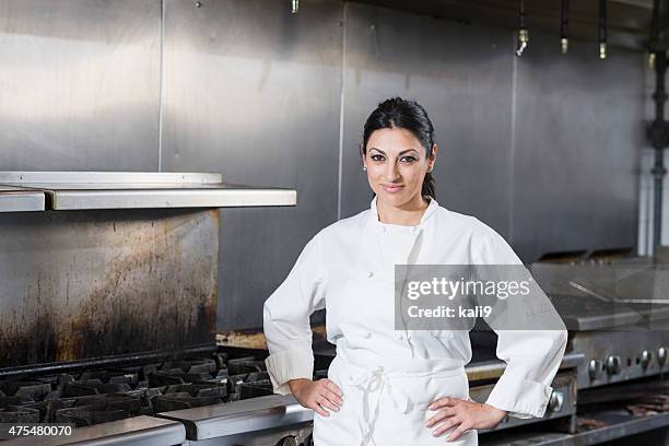 female chef in a commercial kitchen - arms akimbo stock pictures, royalty-free photos & images