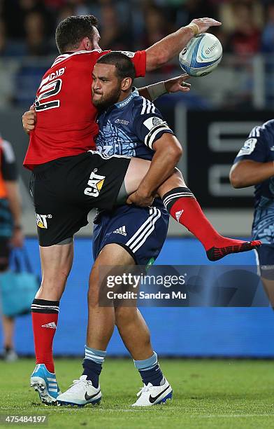 Piri Weepu of the Blues lifts Corey Flynn of the Crusaders in a tackle during the round three Super Rugby match between the Auckland Blues and the...