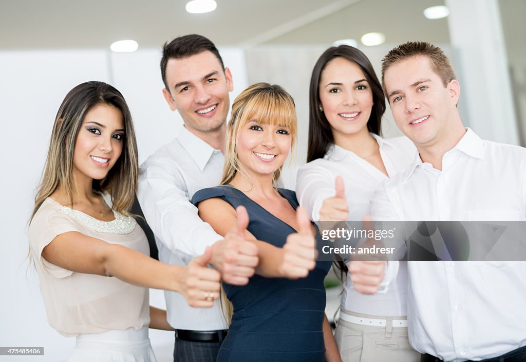 Business team with thumbs up