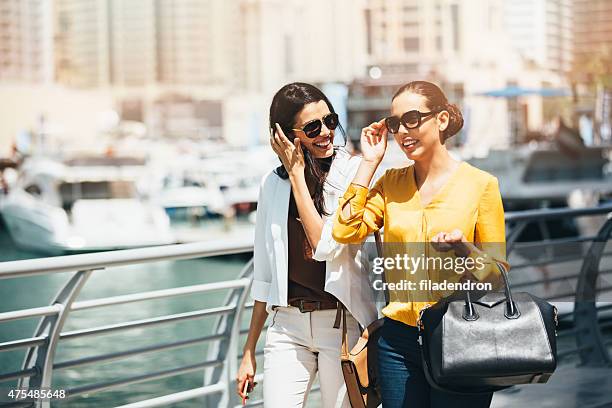 friends walking outdoors - dubai marina stock pictures, royalty-free photos & images