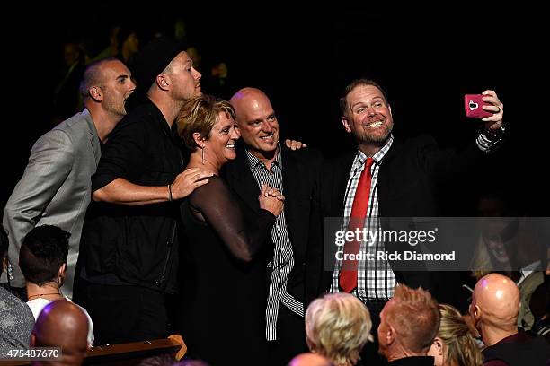 Fan takes a picture with MercyMe during the 3rd Annual KLOVE Fan Awards at the Grand Ole Opry House on May 31, 2015 in Nashville, Tennessee.