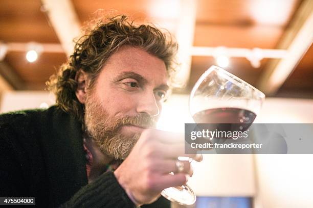 solitude man tasting a wine glass at home - sommelier stock pictures, royalty-free photos & images