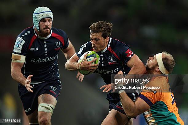 Luke Burgess of the Rebels is tackled during the round three Super Rugby match between the Melbourne Rebels and the Cheetahs at AAMI Park on February...