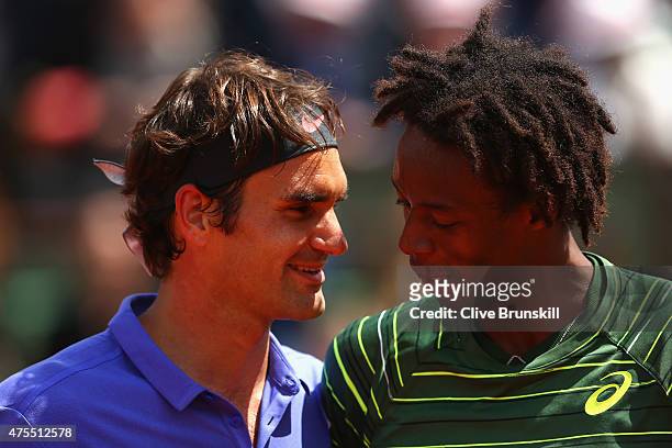 Roger Federer of Switzerland is congratulated by Gael Monfils of France after their Men's Singles match on day nine of the 2015 French Open at Roland...