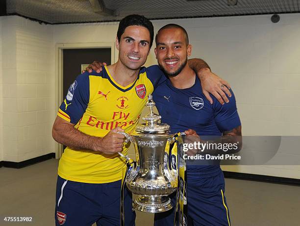 Mikel Arteta and Theo Walcott of Arsenal in the changingroom with the FA Cup Trophy after the match between Arsenal and Aston Villa in the FA Cup...