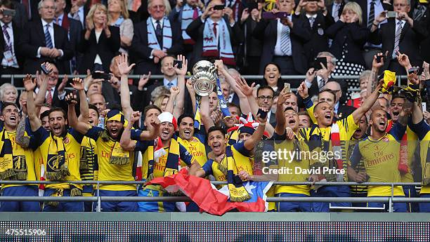 Arsenal team lift the trophy after the match between Arsenal and Aston Villa in the FA Cup Final at Wembley Stadium on May 30, 2015 in London,...