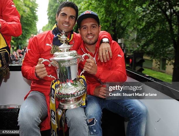 Mikel Arteta and Santi Cazorla during the Arsenal FA Cup Victory Parade in Islington on May 31, 2015 in London, England.