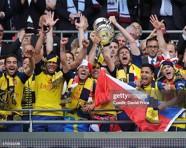 Mathieu Flamini, Francis Coquelin, Santi Cazorla, Mikel Arteta, Per Mertesacker, Alexis Sanchez and Jack Wilshere with the FA Cup Trophy after the...