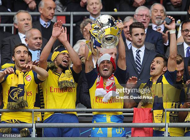 Mathieu Flamini, Francis Coquelin, Santi Cazorla and Alexis Sanchez with the FA Cup Trophy after the match between Arsenal and Aston Villa in the FA...