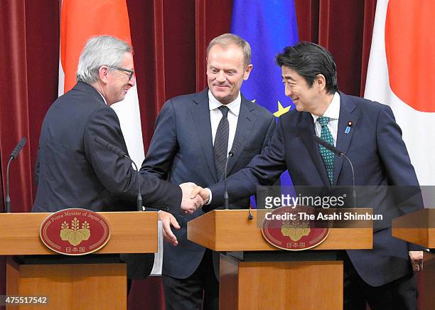 European Commission President Jean-Claude Juncker , European Council President Donald Tusk and Japanese Prime Minister Shinzo Abe shake hands at a...