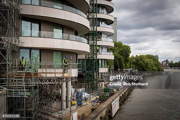 Construction workers are seen on the site of Riverwalk, a 116 luxury apartment building currently under construction by Vauxhall Bridge on June 1,...