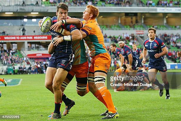 Mitch Inman of the Rebels is tackled by Philip van der Walt of the Cheetahs during the round three Super Rugby match between the Melbourne Rebels and...