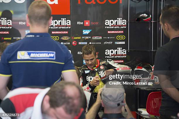 Alvaro Bautista of Spain and Factory Aprilia Gresini speaks with mechanics during the Michelin tires test during the MotoGp Tests At Mugello at...